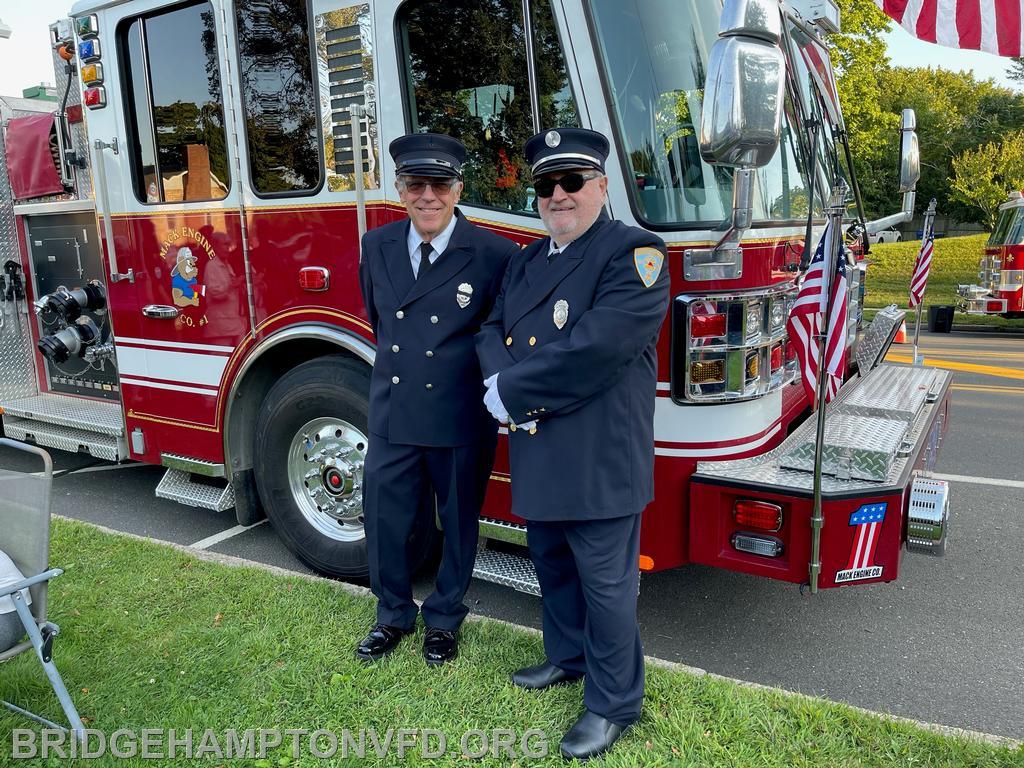 (photo: T. Vecsey) Mack Company members Joe Viviani and Gerard Turza help make the Flag Arch possible. 